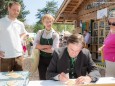 Franz Voves verziert ein Lebkuchenherz am Pirker Stand - Steiermark Frühling 2015 in Wien am Rathausplatz